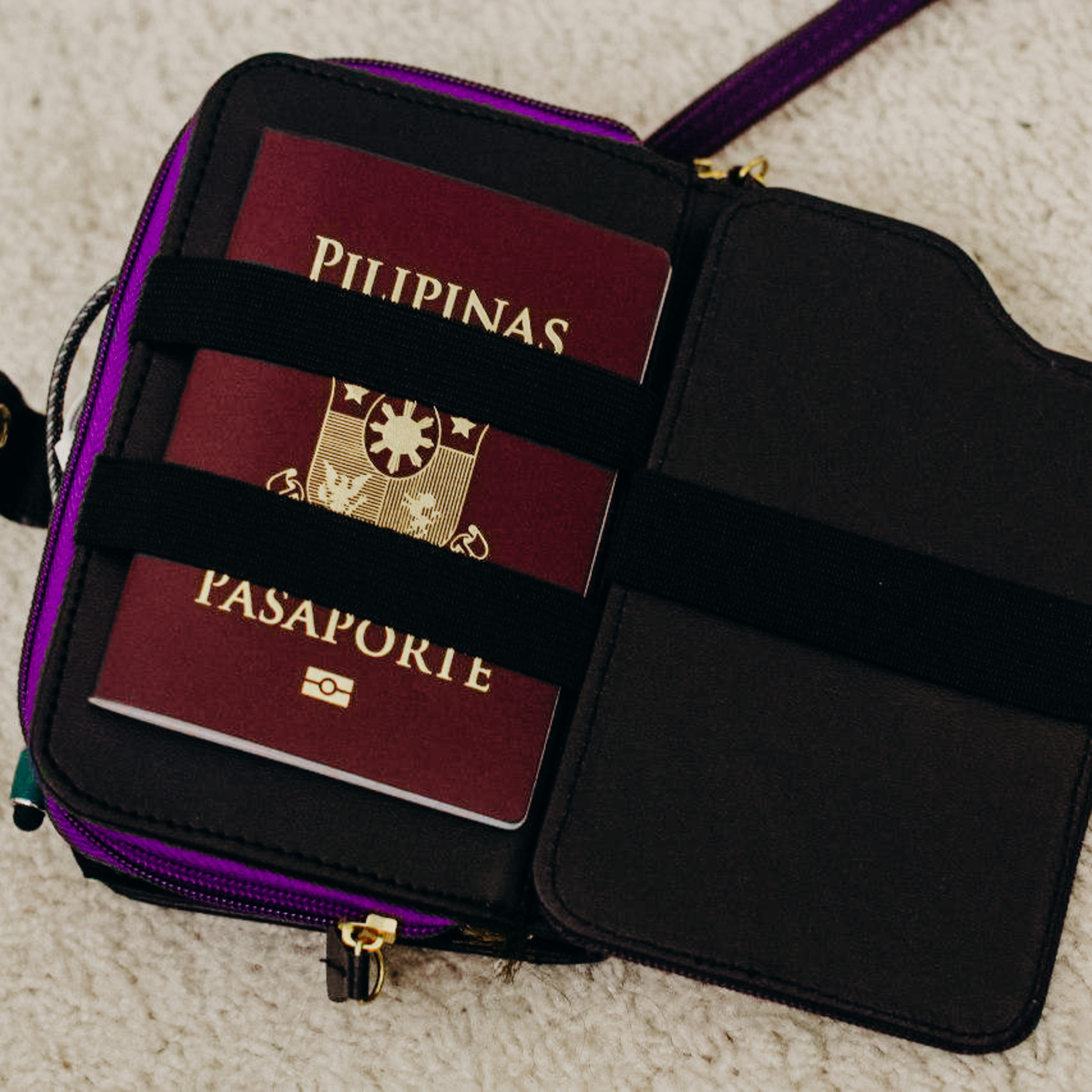 A passport holder at the back of a purple vegan leather wallet.