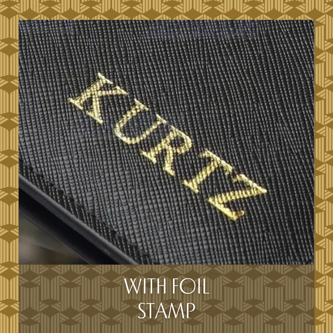 A piece of black vegan leather witha gold foil stamp that reads "KURTZ".